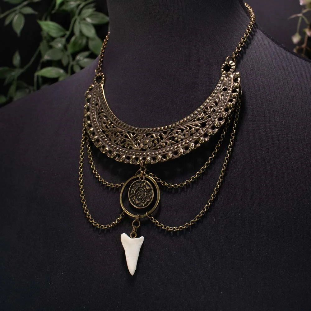 Symbolic protection jewelry displaying the organic texture of deer bone and bronze hardware.