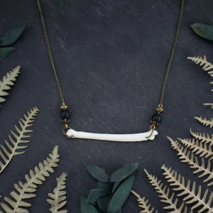 Unique hippie bone jewelry showing the organic texture of fox bone with dark gemstone accents.